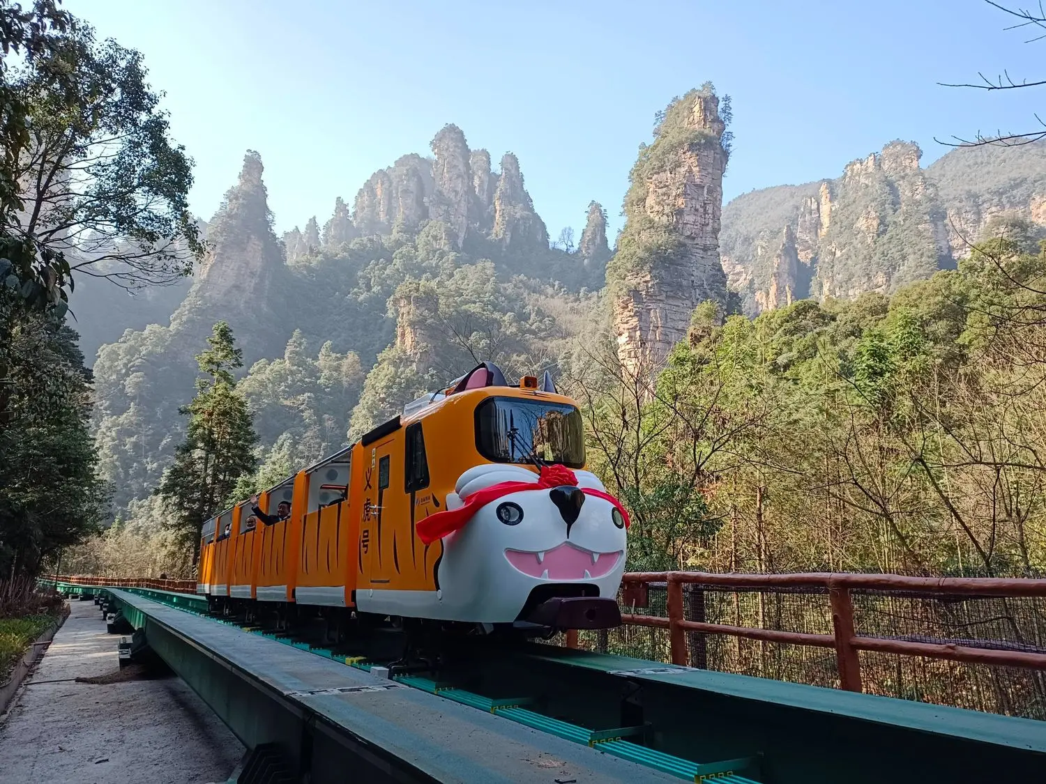 The Zhangjiajie Ten-Mile Gallery sightseeing train winding through the iconic sandstone peaks of Zhangjiajie National Forest Park, Hunan, China.