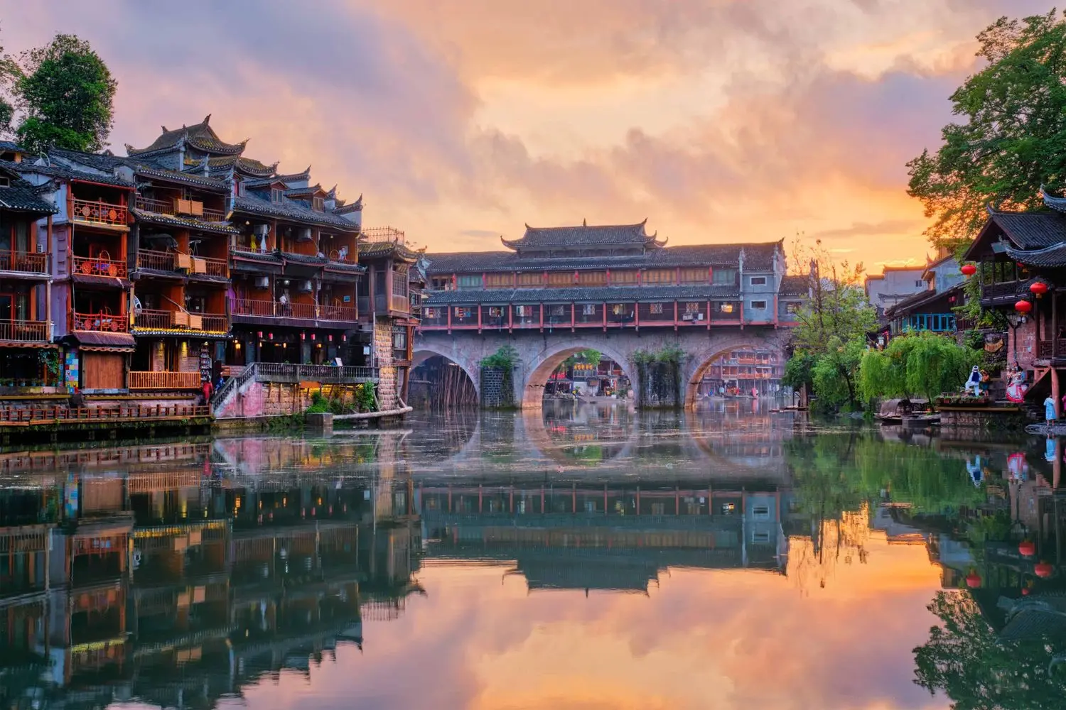 Hongqiao Bridge reflected on the Tuojiang River in Fenghuang Ancient Town, Hunan, China.