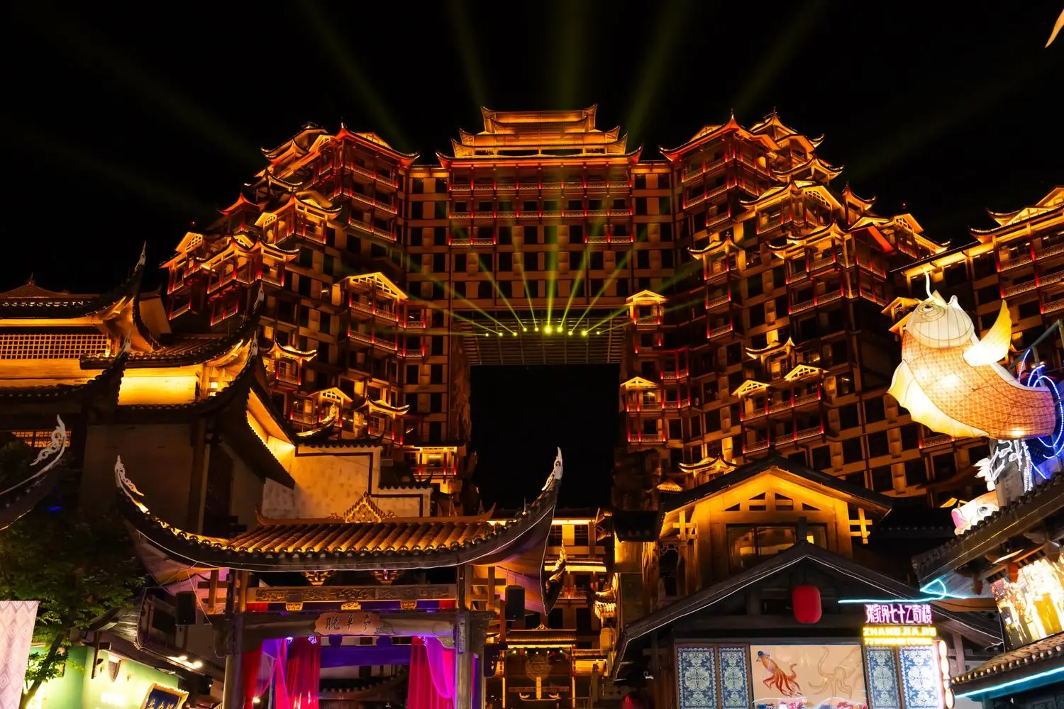 The illuminated Zhangjiajie 72 Wonder Towers, a spectacular night landmark showcasing traditional Chinese architecture in Hunan, China.