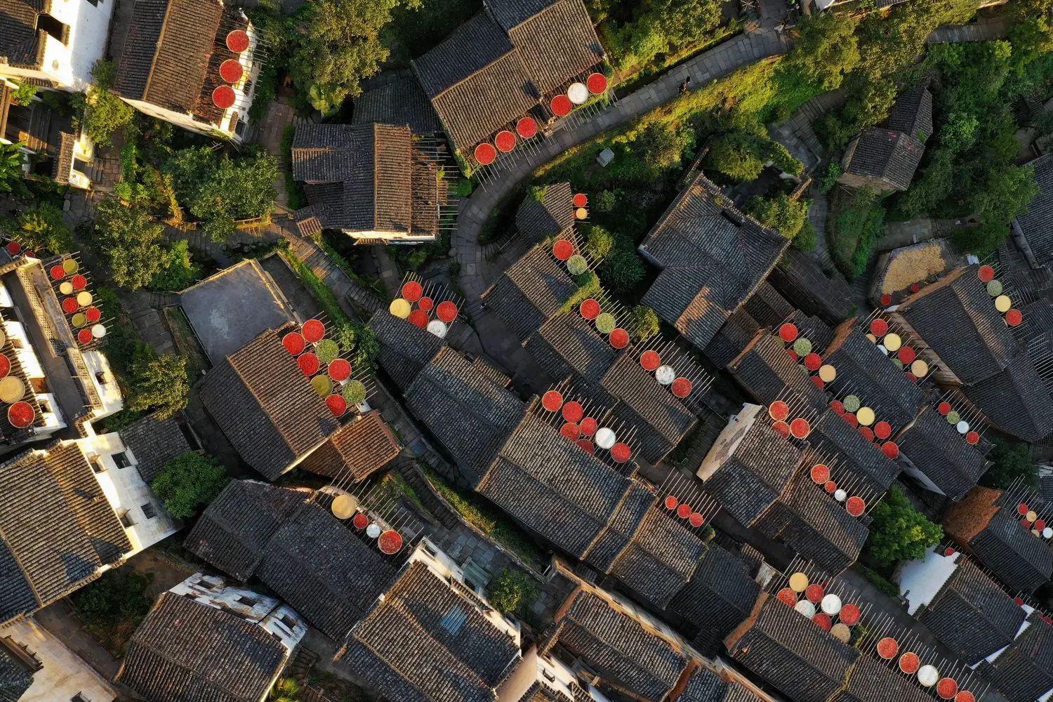 The charming traditional rooftops of Wuyuan Ancient Village, decorated with vibrant red lanterns and showcasing Jiangxi's historic Hui-style architecture.