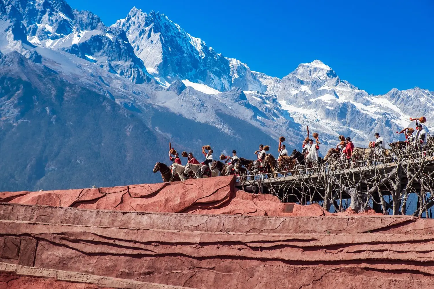 The spectacular Impression Lijiang outdoor performance beneath Jade Dragon Snow Mountain, showcasing Yunnan's ethnic culture and breathtaking alpine scenery.