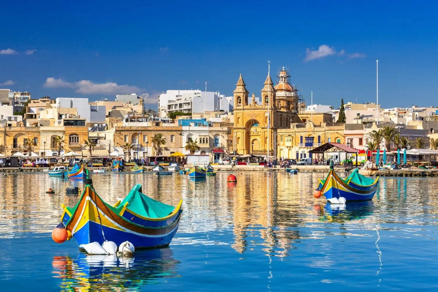The colorful Marsaxlokk Fishing Village in Malta, famous for its traditional Luzzu boats, picturesque harbor, fresh seafood restaurants, and authentic Mediterranean coastal charm.