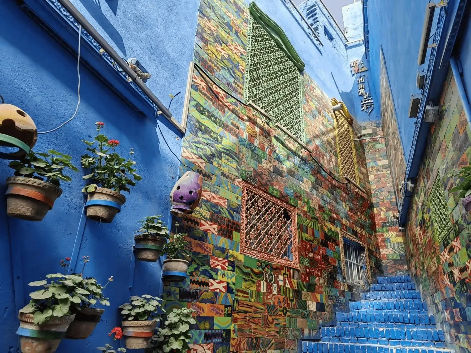 The vibrant Rainbow Alley in Kashgar Ancient City, Xinjiang, China, featuring colorful walls, traditional Uyghur architecture, charming stone streets, and one of Kashgar's most Instagram-worthy photo spots.