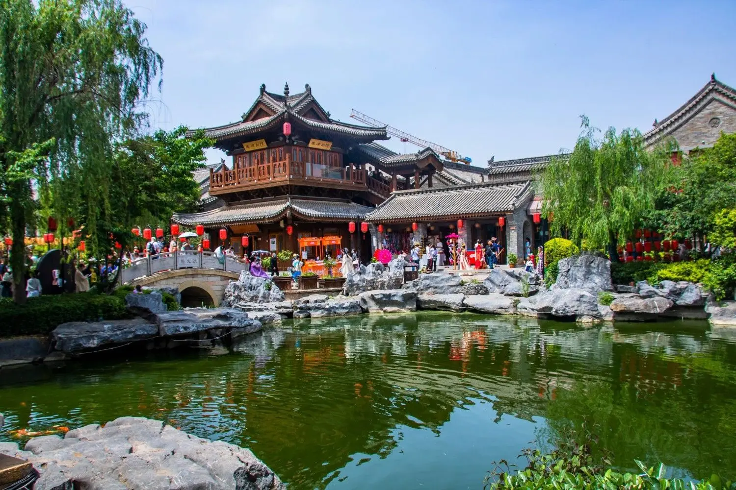 Classical Chinese gardens and traditional architecture at Luoyi Ancient City in Luoyang, Henan, China, featuring elegant pavilions, tranquil ponds, stone bridges, and rich Tang Dynasty cultural heritage.