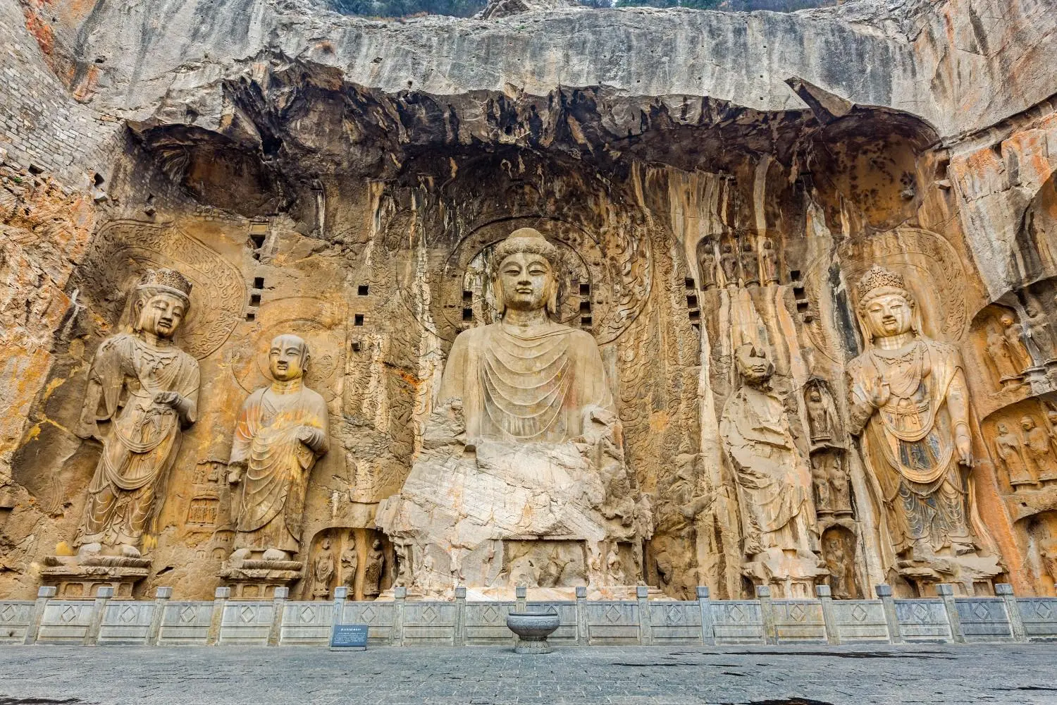 The magnificent Vairocana Buddha and ancient Buddhist stone carvings at Longmen Grottoes in Luoyang, Henan, China, a UNESCO World Heritage Site renowned for its exceptional Chinese Buddhist art and cultural heritage.