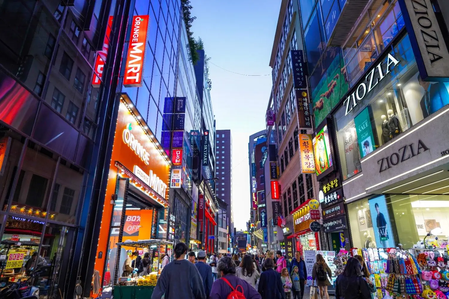 Bustling Myeongdong Shopping Street in Seoul, South Korea, featuring vibrant neon lights, fashion boutiques, cosmetic stores, street food, and one of Korea's most famous shopping destinations.