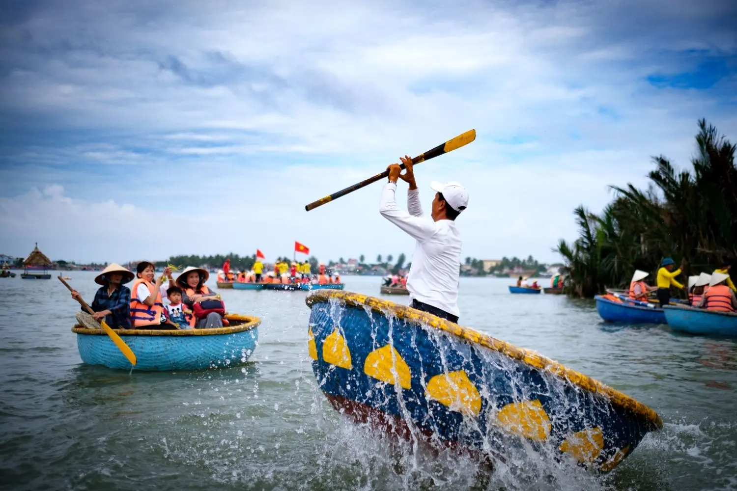 Traditional Vietnamese basket boat performance with a local boatman paddling and spinning a round bamboo boat, showcasing Vietnam's unique river culture and eco-tourism experience.
