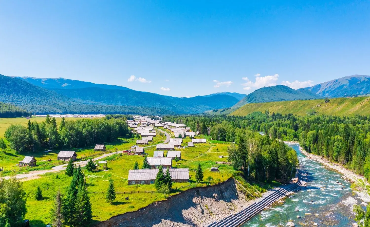 Hemu Village in Xinjiang, China, featuring traditional Tuva wooden houses, winding rivers, lush forests, and breathtaking mountain scenery, one of the most beautiful villages in Northern Xinjiang.