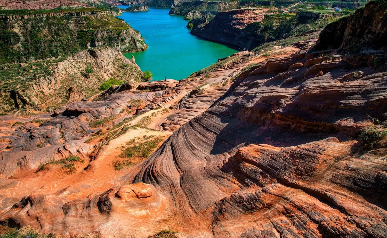 Wave Valley (Jingbian Wave Valley) in Shaanxi, China, featuring dramatic red sandstone formations, naturally sculpted rock waves, and breathtaking canyon scenery, one of China's most spectacular geological landscapes.