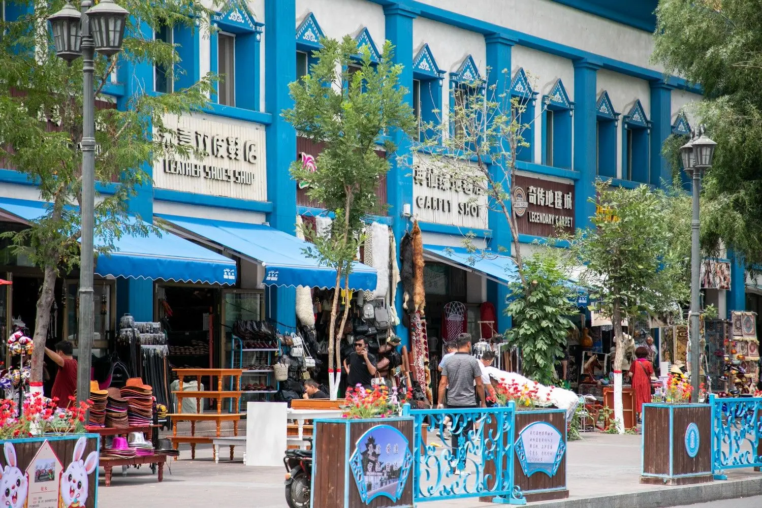 Kazanqi Folk Tourism Area in Yining, Xinjiang, China, featuring vibrant blue Uygur-style architecture, charming cafés, traditional streets, and rich ethnic culture, offering an authentic glimpse into the lifestyle of the Ili region.