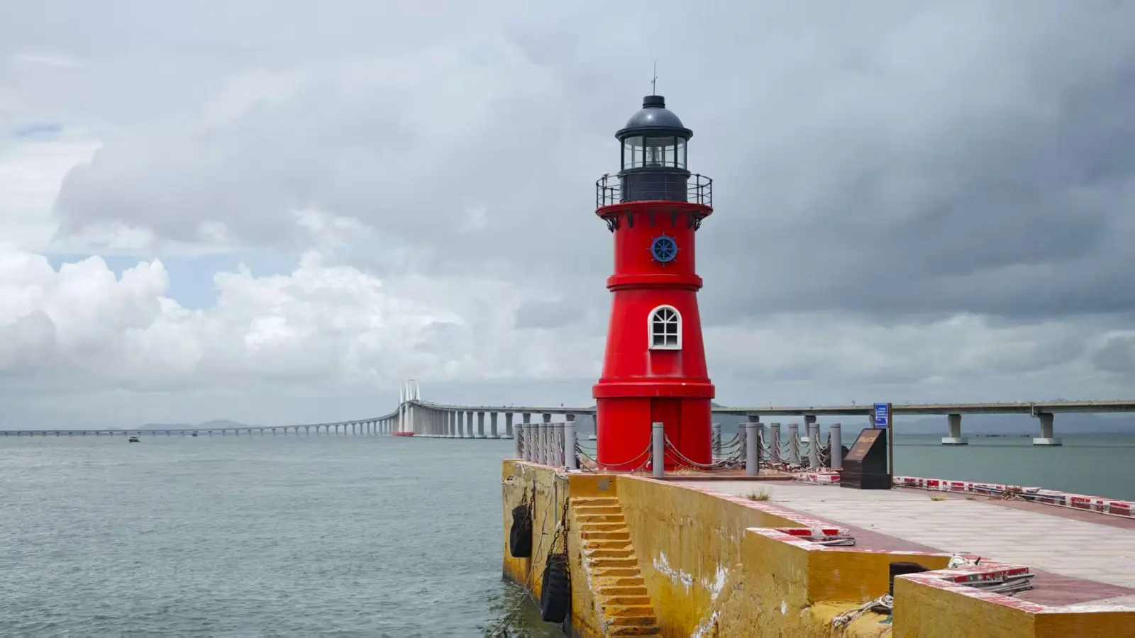 Nan'ao Island Red Lighthouse in Shantou, Guangdong, China, featuring the iconic bright red beacon overlooking the sea with Nan'ao Bridge in the background, one of the island's most popular coastal landmarks.