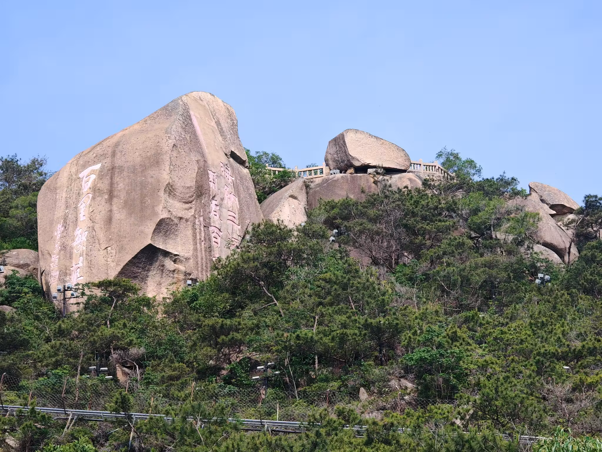 Queshi Scenic Area in Shantou, Guangdong, China, featuring massive granite rock formations, lush hillsides, and panoramic coastal scenery, one of Chaoshan's most iconic natural attractions and a popular destination for hiking and sightseeing.