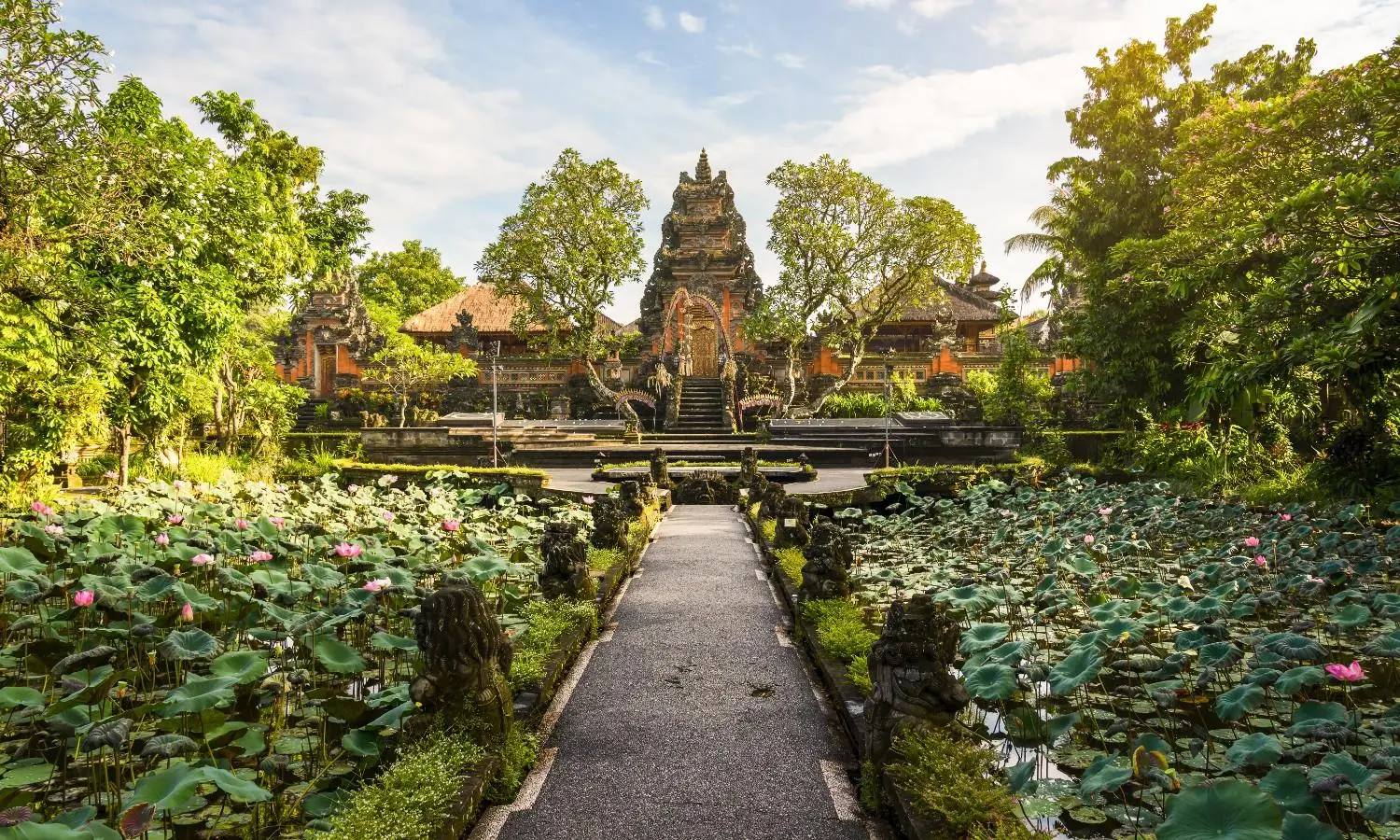 Ubud Palace (Puri Saren Agung) in Ubud, Bali, Indonesia, featuring traditional Balinese royal architecture, lotus ponds, lush tropical gardens, and intricate stone carvings. One of Ubud's most iconic cultural landmarks, renowned for its heritage and traditional dance performances.