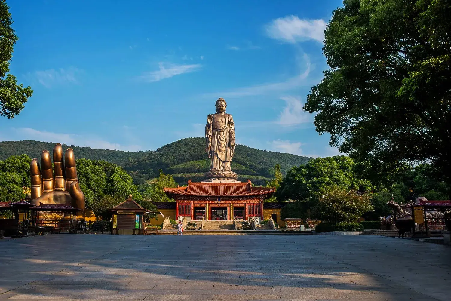 Lingshan Grand Buddha in Wuxi, Jiangsu, China, featuring one of the world's tallest bronze Buddha statues, surrounded by tranquil temples, lush mountains, and sacred Buddhist architecture. A renowned cultural and spiritual landmark, attracting visitors with its magnificent scenery and rich Buddhist heritage.