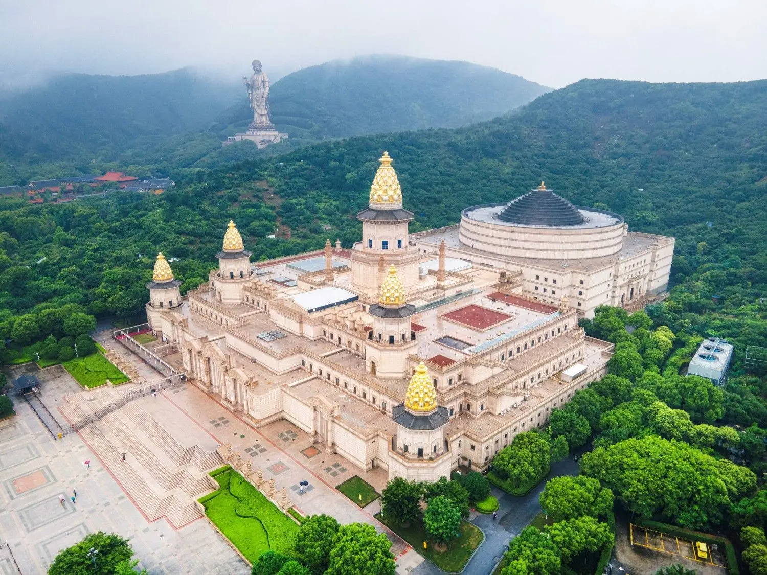 Lingshan Brahma Palace in Wuxi, Jiangsu, China, featuring magnificent Buddhist-inspired architecture, golden pagodas, grand ceremonial halls, and lush mountain surroundings. Part of the renowned Lingshan Scenic Area, this iconic cultural landmark is celebrated for its exquisite design, Buddhist heritage, and spiritual atmosphere.