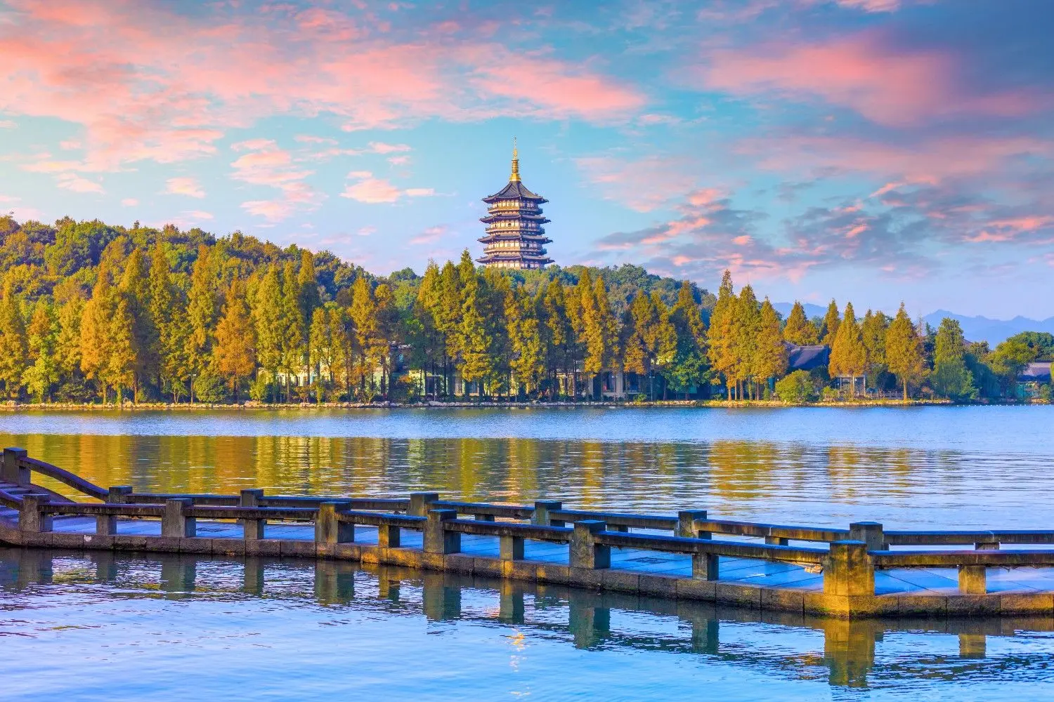 West Lake (Xi Hu) in Hangzhou, Zhejiang, China, featuring the iconic Leifeng Pagoda, tranquil lake waters, scenic wooden boardwalks, and lush lakeside greenery. A UNESCO World Heritage Site and one of China's most celebrated cultural landscapes, renowned for its timeless beauty, historic landmarks, and breathtaking natural scenery.