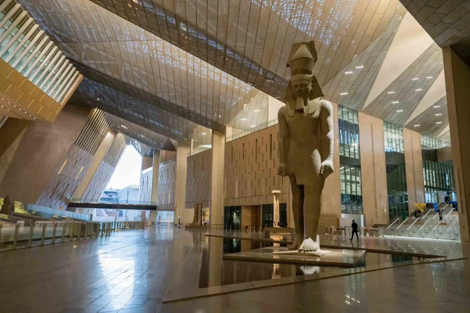 Grand Egyptian Museum in Giza, Egypt, featuring the monumental statue of Pharaoh Ramesses II within its spectacular modern atrium. The museum showcases priceless treasures and artifacts from ancient Egyptian civilization.